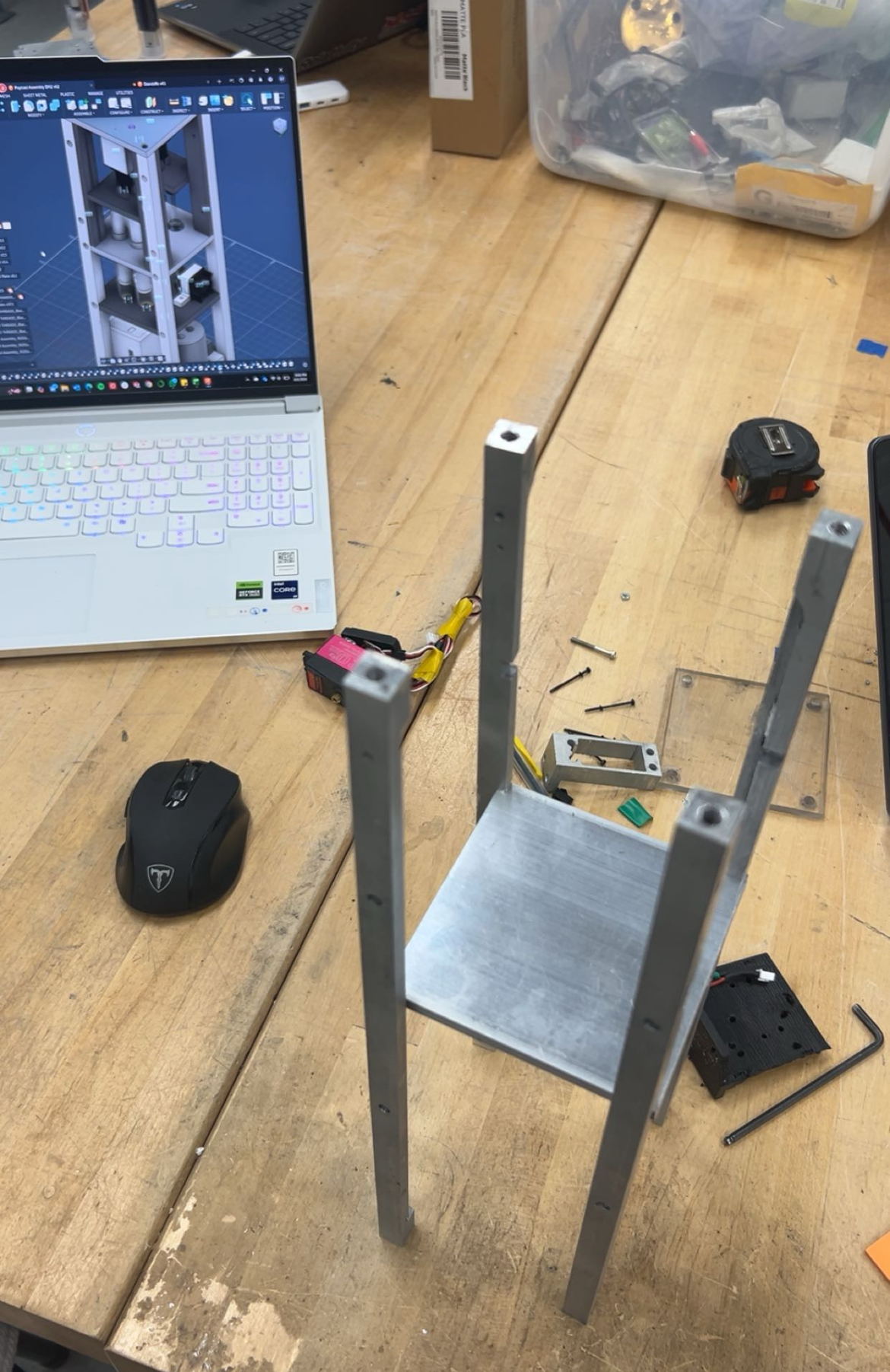 The machined payload frame assembled on a desk